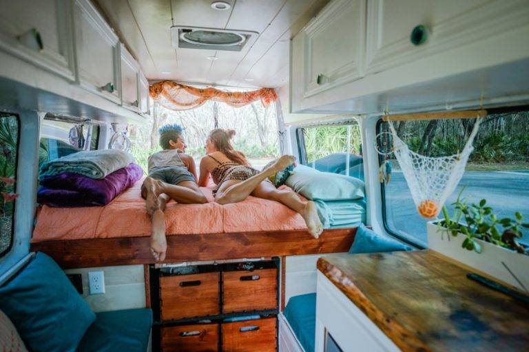 two pull lying on a bed in campervan conversion