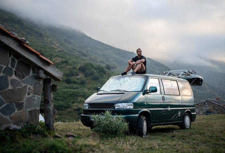 man sitting on campervan conversion